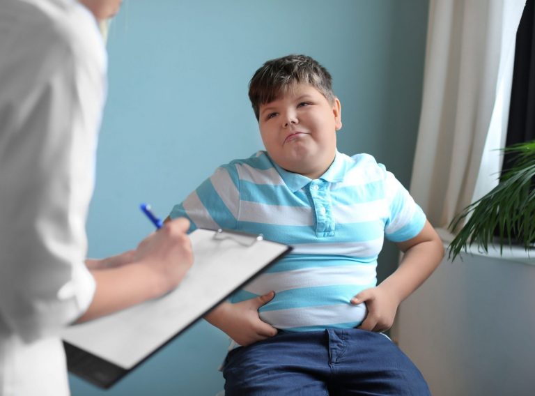 Overweight,Boy,Consulting,With,Doctor,In,Office